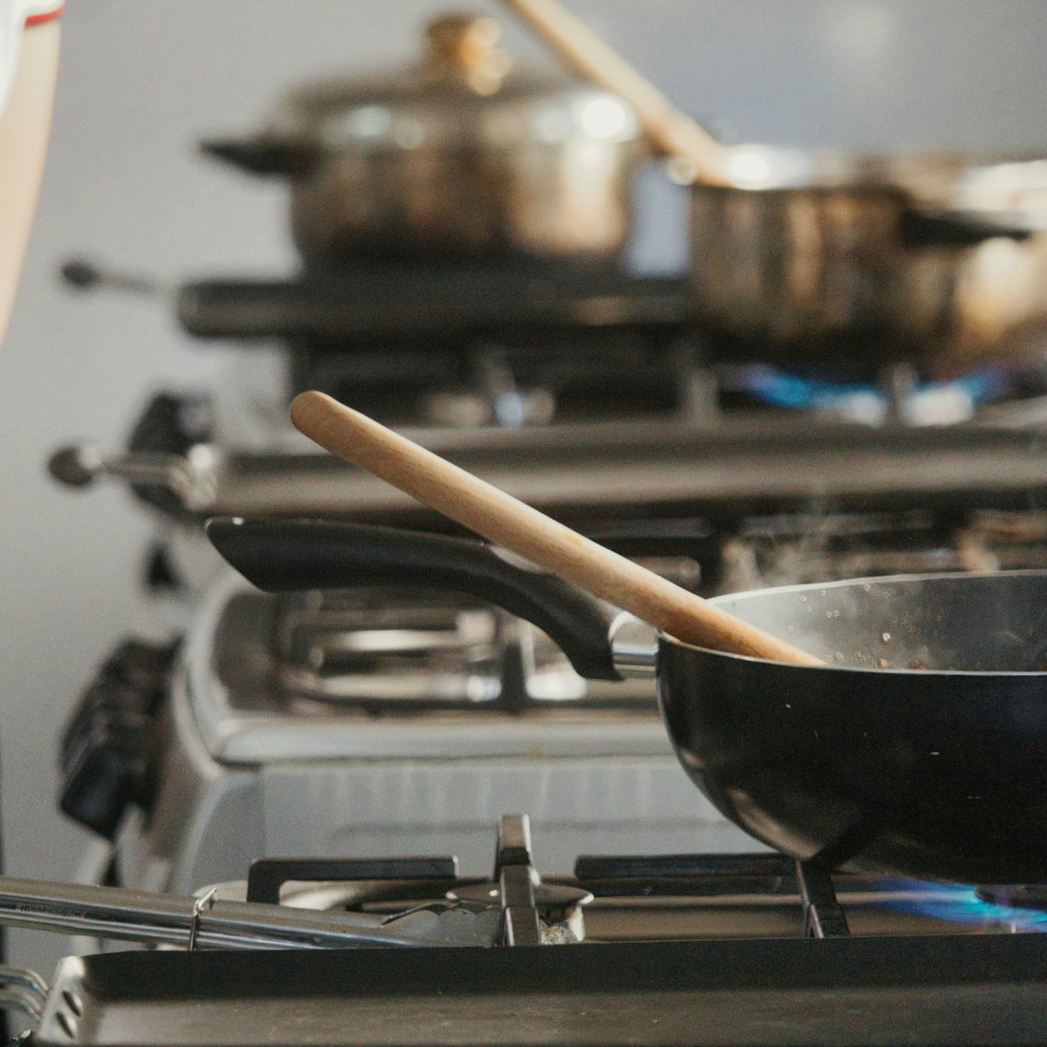 Community members collaborating in a modern kitchen space, sharing recipes and cooking techniques
